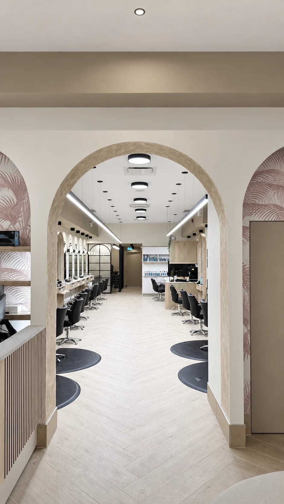 Arched doorway leading from reception to the salon's styling stations